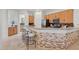 Kitchen with breakfast bar that seats four, stainless steel appliances and tiled backsplash at 11299 E Greythorn Dr, Scottsdale, AZ 85262