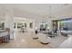 Bright and airy living room featuring neutral tones, tile flooring, and a view of the outdoor pool at 11299 E Greythorn Dr, Scottsdale, AZ 85262