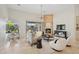 Living room featuring a stone fireplace, neutral furniture, and natural light at 11299 E Greythorn Dr, Scottsdale, AZ 85262