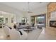 Open concept living room with natural light, neutral furniture, and a view of the backyard at 11299 E Greythorn Dr, Scottsdale, AZ 85262
