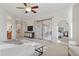 Bright bedroom with ceiling fan, outdoor access, and en-suite bathroom at 11299 E Greythorn Dr, Scottsdale, AZ 85262
