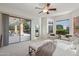 Main bedroom with seating area and sliding doors that lead to the backyard at 11299 E Greythorn Dr, Scottsdale, AZ 85262