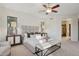 Bright main bedroom features plush carpet, a ceiling fan, and neutral decor at 11299 E Greythorn Dr, Scottsdale, AZ 85262