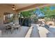 Covered outdoor patio featuring a dining table and chairs perfect for outdoor entertaining and shaded relaxation at 11299 E Greythorn Dr, Scottsdale, AZ 85262
