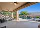 Covered patio with ceiling fans offering comfortable seating and stunning views of the landscaped pool area at 11299 E Greythorn Dr, Scottsdale, AZ 85262