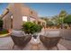 Cozy patio seating area with comfortable chairs, side table and colorful desert landscape at 11299 E Greythorn Dr, Scottsdale, AZ 85262
