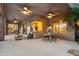 Covered patio with stylish furniture and lighting, perfect for outdoor dining and lounging at 11299 E Greythorn Dr, Scottsdale, AZ 85262