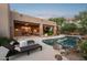 Relaxing backyard pool with lounge chairs and covered patio, ideal for outdoor entertaining at 11299 E Greythorn Dr, Scottsdale, AZ 85262