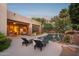 Lovely backyard pool with lounge chairs, tropical plants, and a covered patio area at 11299 E Greythorn Dr, Scottsdale, AZ 85262