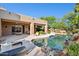 Inviting pool area featuring desert landscaping, boulder accents, and direct access to the home's outdoor living spaces at 11299 E Greythorn Dr, Scottsdale, AZ 85262