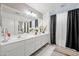 Elegant bathroom with dual sink vanity, large mirror, and white cabinets at 11383 W Pima St, Avondale, AZ 85323