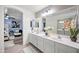 Spacious bathroom featuring a dual sink vanity and view to the primary bedroom at 11383 W Pima St, Avondale, AZ 85323