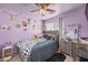 Cozy bedroom featuring a comfortable bed, a ceiling fan, and walls adorned with unique artwork, creating a personalized space at 11383 W Pima St, Avondale, AZ 85323