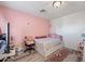 Bright bedroom featuring a twin bed, pink walls and decorative accents at 11383 W Pima St, Avondale, AZ 85323
