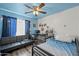 Cozy bedroom equipped with a futon and a gaming setup, providing a comfortable and entertaining space for relaxation and leisure at 11383 W Pima St, Avondale, AZ 85323