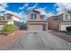 Inviting two-story home featuring a two-car garage, stone accents, and a well-manicured front yard at 11383 W Pima St, Avondale, AZ 85323