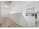 Bright hallway with natural light, a staircase, and modern pendant lighting, offering a stylish and welcoming transition space at 11383 W Pima St, Avondale, AZ 85323