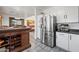 Modern kitchen featuring stainless steel refrigerator and white cabinets at 11383 W Pima St, Avondale, AZ 85323