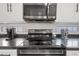 Close-up of kitchen appliances, including a microwave and stove top at 11383 W Pima St, Avondale, AZ 85323