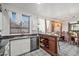 This kitchen features a wooden bar, granite countertops, and a stainless steel dishwasher, perfect for modern living at 11383 W Pima St, Avondale, AZ 85323