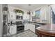 Well-equipped kitchen with white cabinets, stainless steel appliances, and ample counter space at 11383 W Pima St, Avondale, AZ 85323