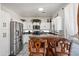 Modern kitchen featuring white cabinets, stainless steel appliances, and a center island at 11383 W Pima St, Avondale, AZ 85323