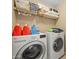 Laundry room featuring a washer, dryer, and storage shelves, providing a functional and organized space for laundry tasks at 11383 W Pima St, Avondale, AZ 85323