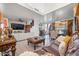 Spacious living room featuring elegant furniture, a decorative coffee table, and views into the dining area, creating an inviting atmosphere at 11383 W Pima St, Avondale, AZ 85323