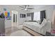 Open and airy primary bedroom featuring a large bed, ceiling fan, and wood flooring at 11383 W Pima St, Avondale, AZ 85323