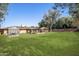 Lush backyard with gazebo, greenhouse, and mature landscaping, creating a private outdoor oasis at 1158 N Barkley St, Mesa, AZ 85203