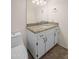 Bathroom features a granite countertop vanity with a sink and a toilet nearby at 1158 N Barkley St, Mesa, AZ 85203