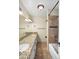 Bathroom features a dual granite vanity, and a tiled shower-tub with a rainfall shower head at 1158 N Barkley St, Mesa, AZ 85203