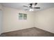 A simple bedroom has carpeted floors, ceiling fan, and a window for natural light at 1158 N Barkley St, Mesa, AZ 85203