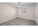 Bright bedroom features a ceiling fan, wood-look tile floors, and a sun-filled window at 1158 N Barkley St, Mesa, AZ 85203