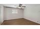 Bedroom boasts wood floors, neutral walls, a ceiling fan, and a window for natural light at 1158 N Barkley St, Mesa, AZ 85203