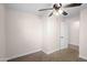 This carpeted bedroom has a ceiling fan and a connecting door to another room at 1158 N Barkley St, Mesa, AZ 85203