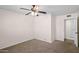 This carpeted bedroom has a ceiling fan and door leading to an adjacent bathroom at 1158 N Barkley St, Mesa, AZ 85203