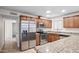 The kitchen boasts granite counters, a stainless fridge, wood cabinets, and modern appliances at 1158 N Barkley St, Mesa, AZ 85203