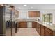 This kitchen has granite countertops, stainless steel appliances, and wood cabinetry at 1158 N Barkley St, Mesa, AZ 85203