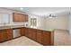 Eat-in kitchen features wood cabinetry, a stainless steel dishwasher, and granite countertops at 1158 N Barkley St, Mesa, AZ 85203