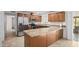 Well-lit kitchen features stainless steel appliances, granite countertops, and wood cabinetry at 1158 N Barkley St, Mesa, AZ 85203