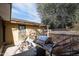 Outdoor kitchen area with stainless steel grill, countertop space, and gas tank storage on a concrete patio at 1158 N Barkley St, Mesa, AZ 85203