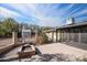 Paver patio with a built-in fire pit and connection to the enclosed sun room at 1158 N Barkley St, Mesa, AZ 85203