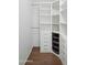 Organized walk-in closet features custom shelving, drawers, and hanging rods for optimal storage at 1158 N Barkley St, Mesa, AZ 85203