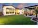 Beautiful backyard showcasing artificial turf, modern pavers, cozy fire pit, pergola, and elegant home exterior at 1160 E Peach Tree Dr, Chandler, AZ 85249