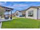 Beautiful backyard with a pergola, outdoor seating, and manicured green lawn at 1160 E Peach Tree Dr, Chandler, AZ 85249