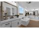 Bright bathroom features double vanity, soaking tub, and stylish fixtures at 1160 E Peach Tree Dr, Chandler, AZ 85249
