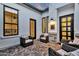 Charming courtyard with brick-paved patio, modern windows, black door frames, and cozy wicker furniture at 1160 E Peach Tree Dr, Chandler, AZ 85249