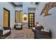 Charming courtyard with brick-paved patio, cozy wicker chairs, and elegant stone wall decoration at 1160 E Peach Tree Dr, Chandler, AZ 85249