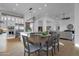Open-concept dining room showcasing wood floors, modern lighting, with seamless access to the kitchen and living area at 1160 E Peach Tree Dr, Chandler, AZ 85249